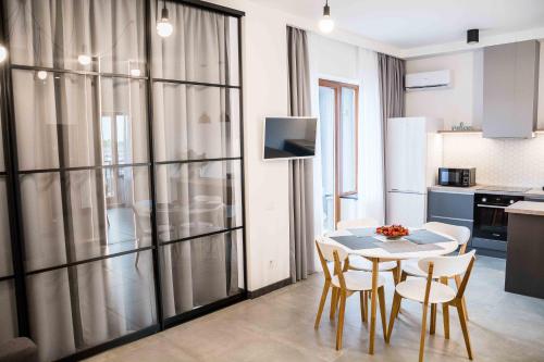 a kitchen and dining room with a table and chairs at Bolshaya Arnautskaya Apartment in Odesa