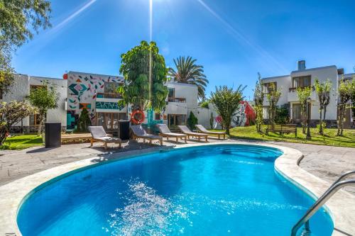 a swimming pool in front of a house at Selina Arequipa in Arequipa