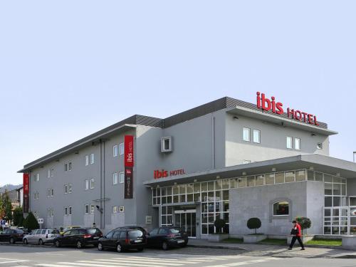 a large building with a large clock on the front of it at Hotel ibis Guimaraes in Guimarães