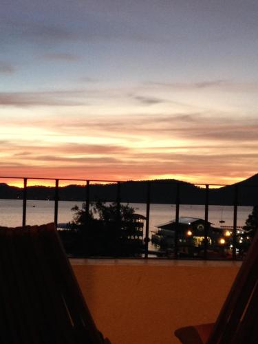 a view of a sunset from a balcony at Hotel puesta del sol in Valle de Bravo