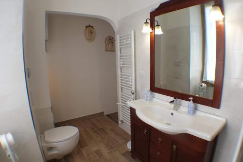 a bathroom with a sink and a toilet and a mirror at Casa Ferrari Testaccio e Trastevere Wi-Fi free in Rome