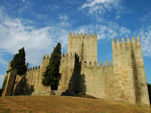 a large castle on top of a hill at Hotel ibis Guimaraes in Guimarães