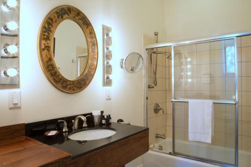 a bathroom with a sink and a shower and a mirror at Wedmore Place in Williamsburg