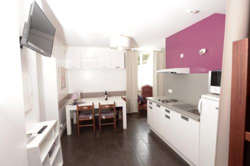 a kitchen with a table and a dining room at Ondoria in Itxassou