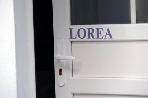 a white door with the word loreza on it at Ondoria in Itxassou