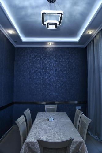 a dining room with a table and a projector at Lara Hotel in Goris