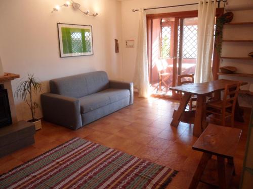 a living room with a couch and a table at Appartamento Cisto in Olbia