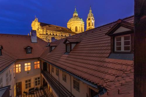 a view of the town hall at night at Three Golden Crowns Apartments in Prague