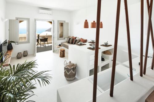a white living room with a view of the ocean at Star Infinity Suites in Pirgos