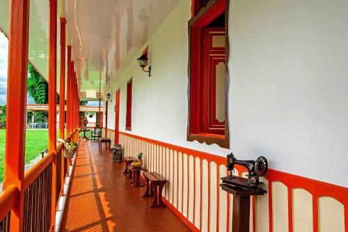 a hallway of a building with benches and windows at Hotel Terra Tacuara in Armenia