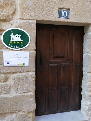 a door to a building with a sign on it at El Mirador de Eloísa in Rodezno