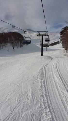 a ski lift on a snow covered ski slope at Etna Sunshine in Linguaglossa