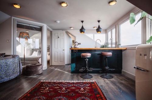 a kitchen with a counter and a bar with stools at Star & Garter in Falmouth