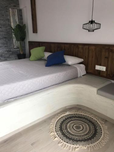 a bedroom with two beds and a rug on the floor at Kostas Studios in Faliraki