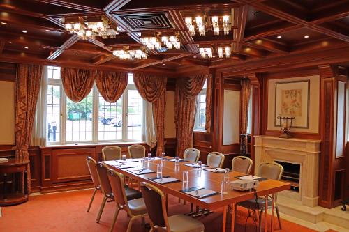 a conference room with a long table and chairs at Fredrick's Hotel Restaurant Spa in Maidenhead