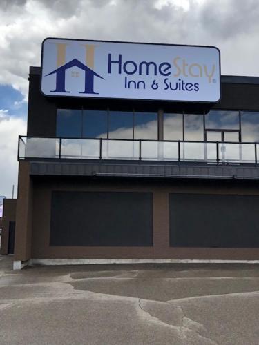 a sign on top of a home buy inn and suites at Wyndham Garden Medicine Hat Conference Center in Medicine Hat