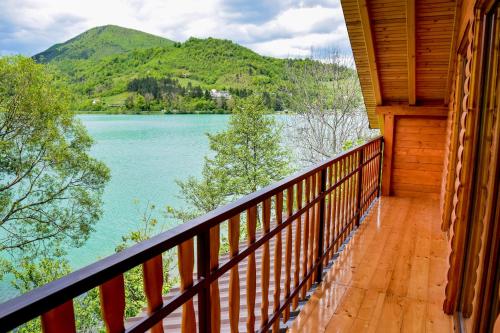 a balcony of a cabin with a view of a lake at Forest Dream Lake House in Jajce