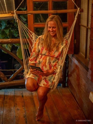a woman is sitting in a hammock at Natura Vista in Panglao