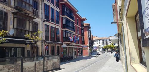 an empty street in a city with buildings at Gran Hotel Paraiso in Llanes