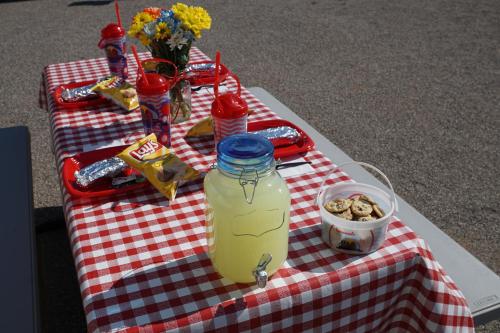a picnic table with a jar of juice and snacks at Orr Family Farm & RR, LLC in Oklahoma City