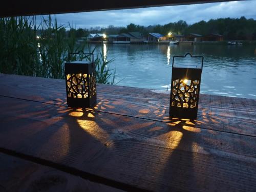 two lights sitting on a table near a body of water at Cottage Ajna - Ada Bojana in Ulcinj