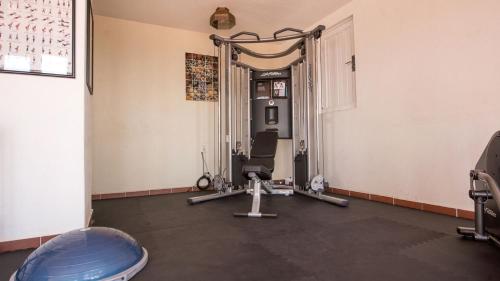 a room with a gym with a treadmill at Casa Estrella de la Valenciana Hotel Boutique in Guanajuato