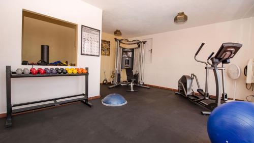 a room with a gym with weights and exercise equipment at Casa Estrella de la Valenciana Hotel Boutique in Guanajuato