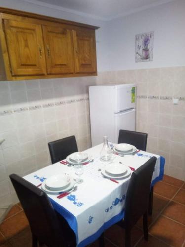 a table with a blue and white table cloth on it at Casa Viela in Viseu