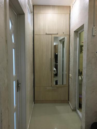a hallway with a wooden door and a mirror at Апартаменты свидом наморе Гонио in Kvariat'i