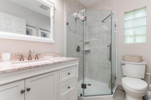 a bathroom with a shower and a toilet and a sink at Beach & Waterway RFV Resort BB in Hillsboro Beach