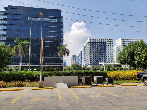 a parking lot with chairs in front of some buildings at Shell Residence Manila in Manila