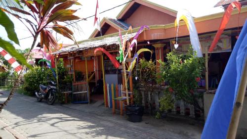 a building with plants in front of it at Novita Homestay in Bunaken