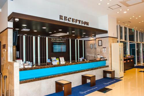 a hotel lobby with a reception counter and benches at Toyoko Inn Daegu Dongseongro in Daegu