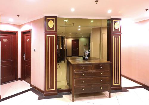 a dressing room with a dresser and a mirror at Seventh Heaven Hotel in Shanghai