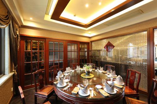 a large dining room with a table and chairs at Seventh Heaven Hotel in Shanghai