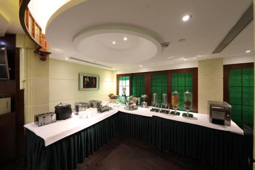 a large room with a counter with glasses in it at Seventh Heaven Hotel in Shanghai