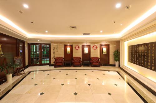 a lobby with a pool in the middle of it at Seventh Heaven Hotel in Shanghai