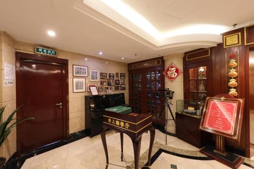 a hotel lobby with a desk in a room at Seventh Heaven Hotel in Shanghai