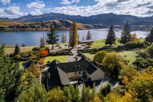 an aerial view of a house next to a lake at The Shan's Lodge in Queenstown