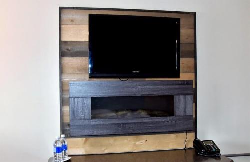 
a flat screen tv sitting on top of a wooden stand at Bras d'Or Lakes Inn in St. Peter's

