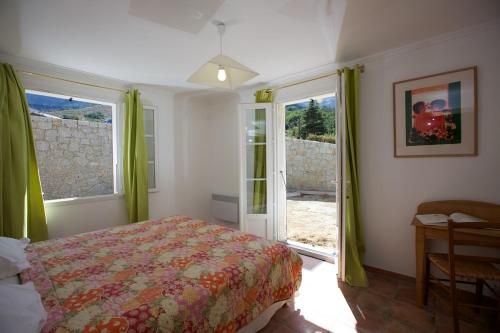 a bedroom with a large bed and a painting on the wall at Casa Vanella in Casamaccioli