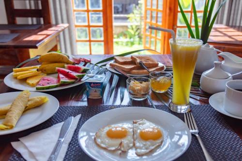 a table with two plates of breakfast food and drinks at Shadow Inn ella in Ella