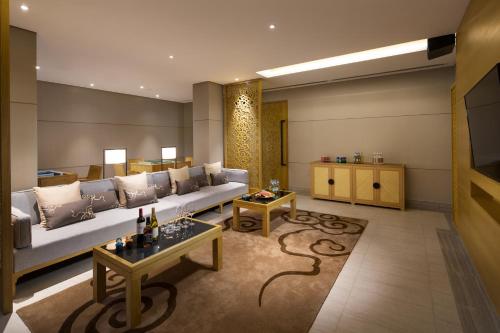 a living room with a couch and a table at Banyan Tree Huangshan in Huangshan