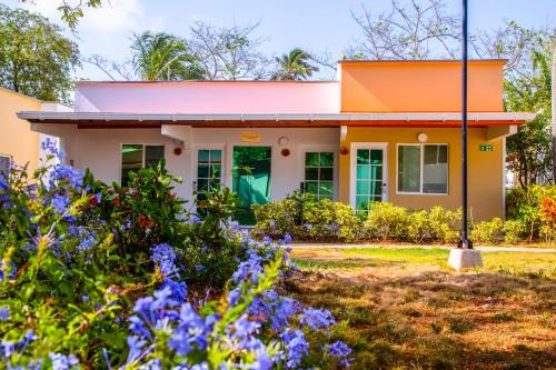 a house with an orange roof and flowers at Solare SAI Ecohotel in San Andrés