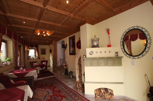 a living room with a fireplace and a mirror at Waldhof in Gerlos
