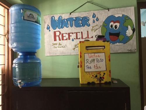 a bottle of water sitting on top of a dresser at Nepalaya Eco Hostel in Pokhara