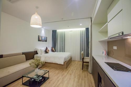 a hotel room with a bed and a couch at Parosand Hanoi Hotel in Hanoi