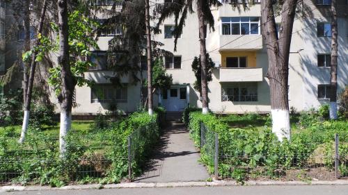 a building with a sidewalk in front of it at Robert 's apartament in Ploieşti