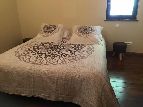 a bed with a white comforter and pillows at Mas Graffouil in Prats-de-Mollo-la-Preste