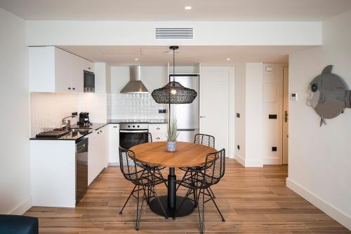 a kitchen and dining room with a table and chairs at Hotel Els Pins in Platja  d'Aro